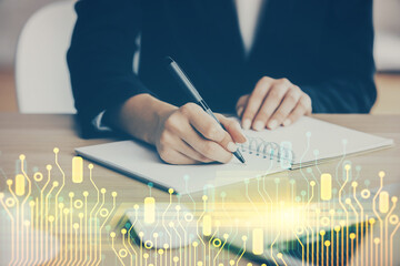 Double exposure of writing hands on background with data solution hologram on front. Technology...