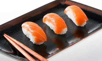 Traditional japanese nigiri and maki sushi on the plate, board and table.