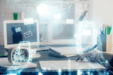 E-mail abstract envelop drawing over hands taking notes background. Concept of electronic mail....