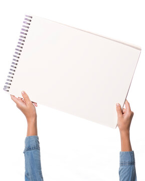 child's hands holding a drawing block
