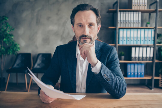 Close-up portrait of his he nice attractive man skilled professional expert reading cv document hiring talented staff it company development at modern concrete industrial work place station