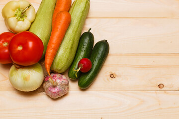 Autumn cooking background with seasonal organic vegetables on wooden table, top view, copy space.