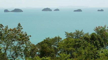Five Sisters Islands in serene water surface. Enchanting landscape, greenery and deep calm water, Samui Thailand. Relax travel vacation holiday resort concept. Bird eye panoramic aerial drone top view