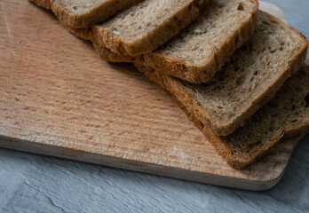 
Bread lies on a kitchen board and spikelets of wheat