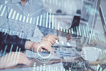 Technology theme hologram with man working on computer on background. High tech concept. Multi exposure.