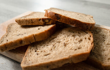 
Bread lies on a kitchen board and spikelets of wheat