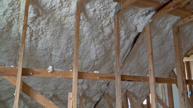 New home construction with installation of termal insulation installing at the attic the roof