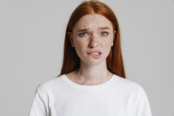 Obraz premium Image of unhappy ginger beautiful girl looking at camera