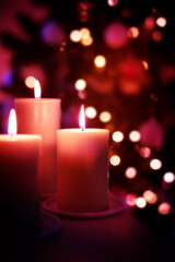 Obraz na płótnie Canvas hristmas candles on garland lights blurred background, copy space