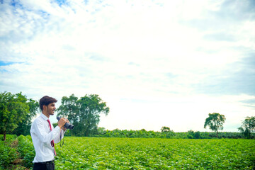 Indian man enjoys in nature with binoculars