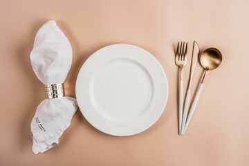 Festive Christmas, Wedding or Birthday table setting with golden cutlery