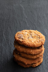 Homemade soft cookies with chocolate drops and coconut on stone bacground