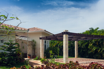 Fototapeta premium Beautiful Luxurious villa with an own swimming pool in Dominican Republic. summer residence on luxury Caribbean resort and beautiful garden.