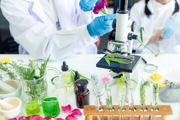 Asian girl leaning and education with woman science lab research flower with microscope for Natural...
