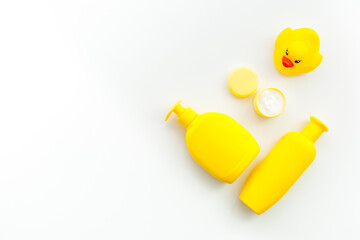 Bath cosmetics and Toy for child. Shampoo, gel, cream, soap and towel. White background top view