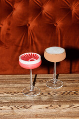 Cocktails in a glass on a red corduroy background. Restaurant, bar. Luxury concept.