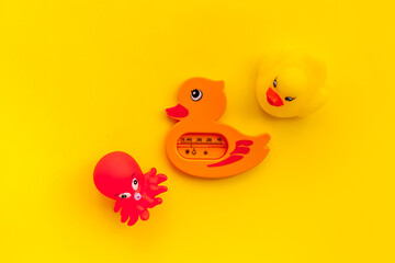 The concept of children’s bath toys. Yellow background top view copyspace