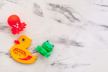 The concept of children’s bath toys. gray stone background top view copyspace
