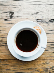 White cup of hot coffee on table