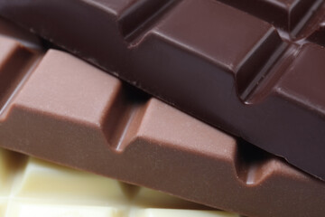 Different delicious chocolate as background, closeup view