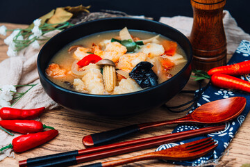 Bowls of Asian soup noodles and vegetables with Chopstick