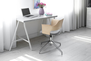 Comfortable workplace with office chair and modern table