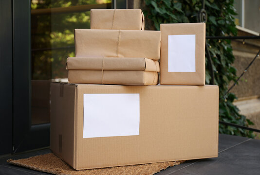 Delivered parcels on door mat near entrance
