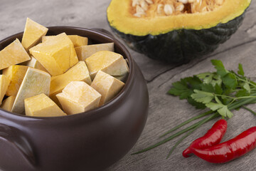 Kabocha pieces on a bowl with half fruit