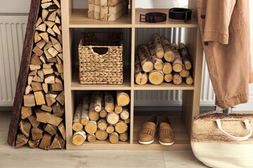 Stylish room interior with firewood as decorative element