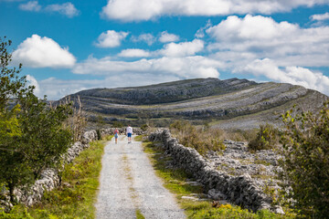 tourists walking through the Burren national park in County Clare, Ireland