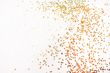 Gold decorative stars background on a white background. Flat Lay style