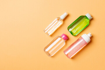 Cosmetics SPA branding mock-up, top view with copy space. set of tubes and jars of cream flat lay on colored background