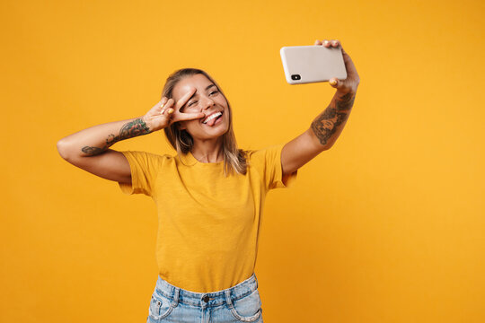 Smiling young girl taking a selfie on smartphone