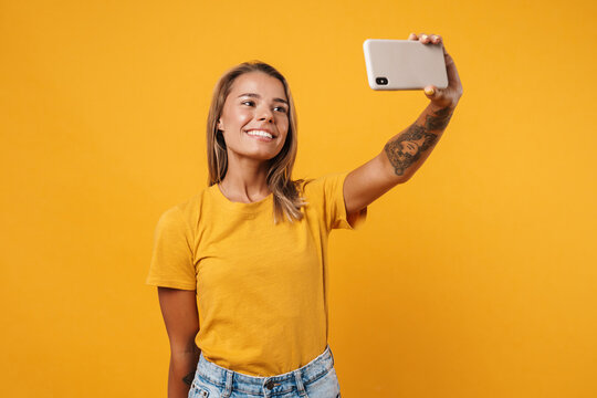 Smiling young girl taking a selfie on smartphone