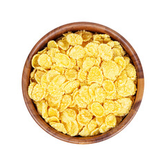 Top view of golden yellow crunchy corn flakes cereal in a round wooden bowl isolated on white background.