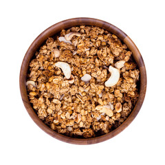 Brown homemade baking cereal granola with nuts for breakfast in a round wooden bowl isolated on white background.