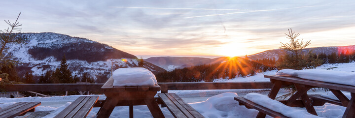 Beautiful winter sunset in the mountains. Wonderful view from the terrace