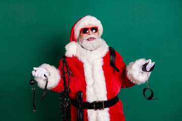 Portrait of his he nice attractive cheerful cheery bearded funny Santa father holding in hands...