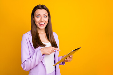 Photo of crazy business lady holding e-reader read good news directing finger screen showing amazing discount price wear lilac suit isolated yellow color background