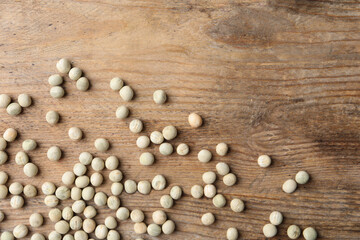 Raw dry peas on wooden background, flat lay. Vegetable seeds