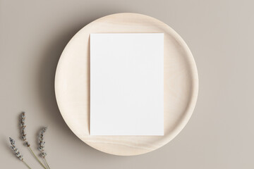 White invitation card mockup on a wooden plate with lavender. 5x7 ratio, similar to A6, A5.