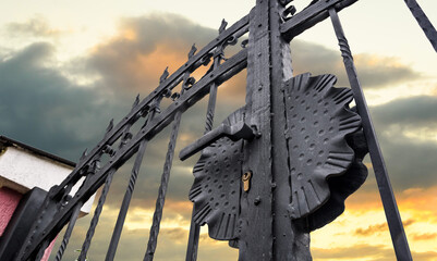 wrought iron fence gate against sky
