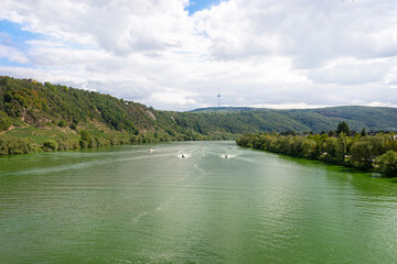 The Moselle river in western Germany near the mouth of the river in Koblenz in the background water scooter and boat, the water flows calmly.