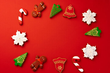 Fototapeta na wymiar Christmas gingerbread cookies on red background top view
