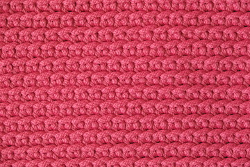 Fototapeta premium Pink knitted material texture background. Top view. Copy, empty space for text