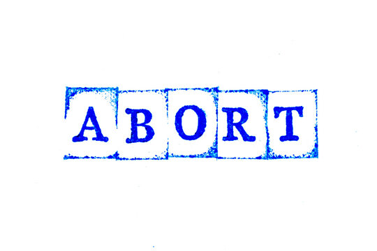 Blue color ink of rubber stamp in word abort on white paper background