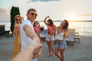 Group of happy people enjoying fun party outdoors