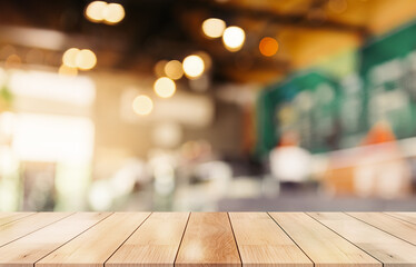 Empty wooden table top with lights bokeh on blur restaurant background
