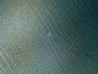 Aerial drone view. Fishing boat on the waves of the river.