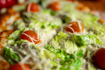 Homemade pinsa with tomatoes, mozzarella and pepperoni.